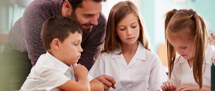 “students-working-at-desk-in-classroom“