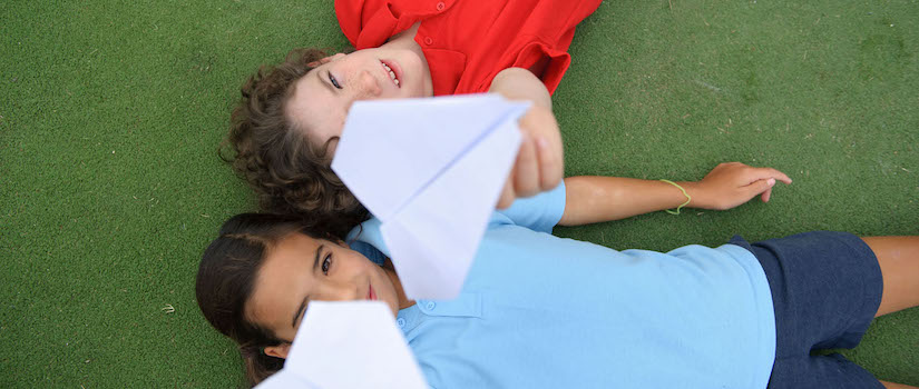 “students-playing-with-paper-planes“