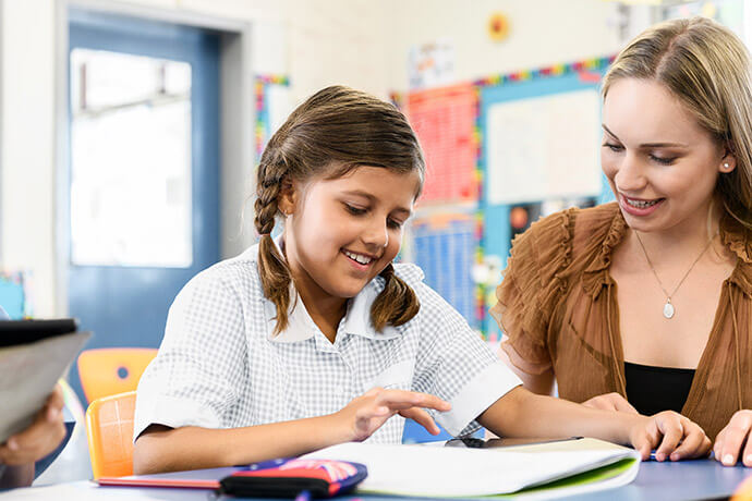 teacher working with student