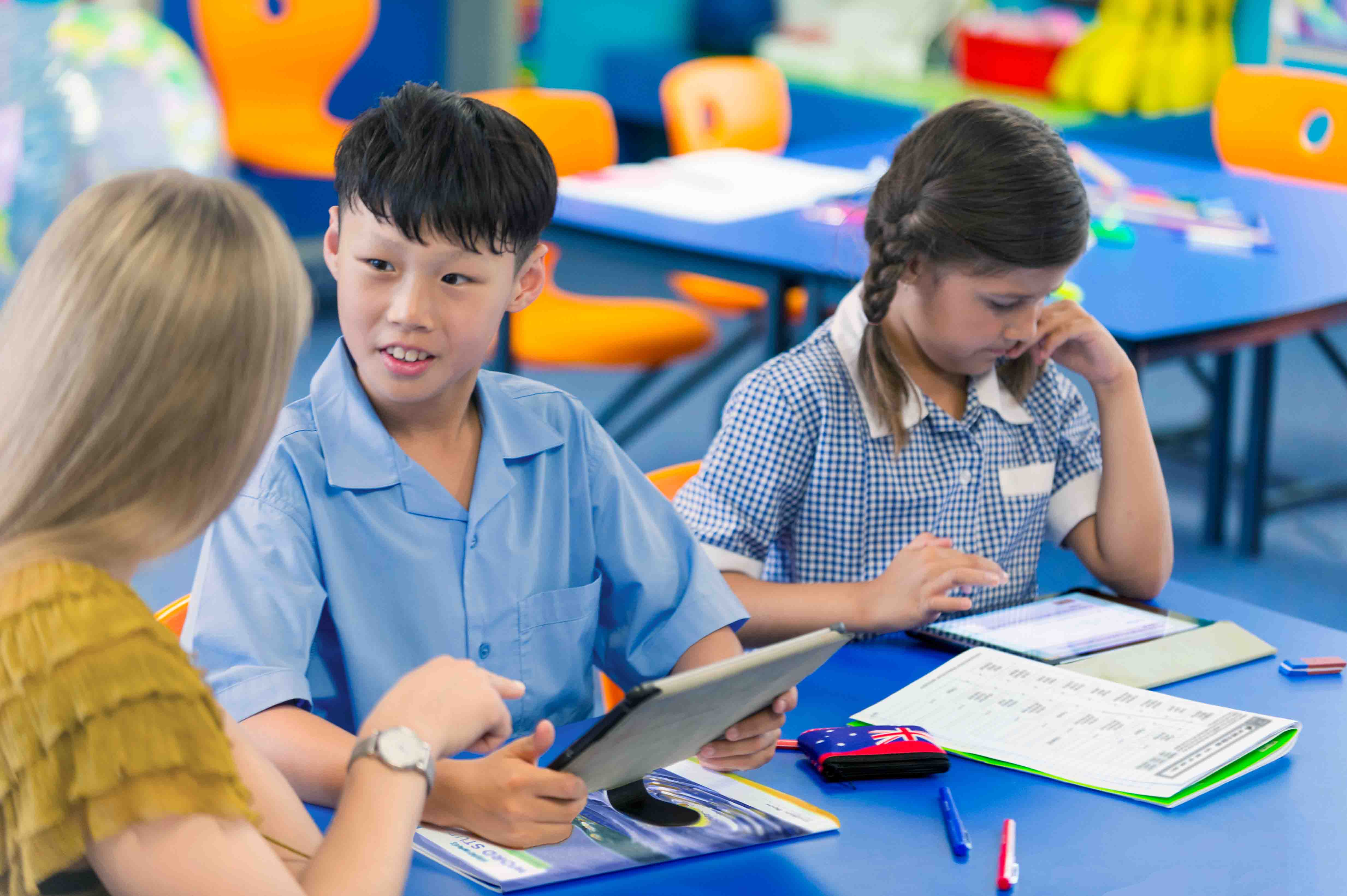 teacher with two students at desk